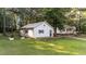 Detached one car garage featuring blue door and window trim with a well manicured lawn at 300 Plantation Rd, Clayton, NC 27520