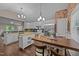 Spacious kitchen with stainless steel appliances, granite countertops, and a dining area for casual meals at 300 Plantation Rd, Clayton, NC 27520