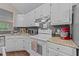 Kitchen with white cabinets, granite countertops, subway tile backsplash, and stainless steel appliances at 300 Plantation Rd, Clayton, NC 27520