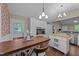 Eat-in kitchen area has wood-look flooring, a white door to the back yard, and kitchen island at 300 Plantation Rd, Clayton, NC 27520