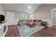 Cozy living room featuring vaulted ceilings, a ceiling fan, and a comfortable seating area with stylish decor at 300 Plantation Rd, Clayton, NC 27520