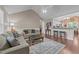 Open-concept living room with hardwood floors, vaulted ceilings, and a smooth transition to the kitchen bar at 300 Plantation Rd, Clayton, NC 27520