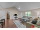 Spacious living room with vaulted ceilings, wood floors, and a view into the kitchen through a pass-through at 300 Plantation Rd, Clayton, NC 27520