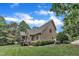 Beautiful view of the house from the backyard, surrounded by lush landscaping and blue sky at 3007 Krogen Ct, Creedmoor, NC 27522