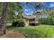 Expansive backyard showcasing lush lawn, mature trees, and the home's rear exterior at 3007 Krogen Ct, Creedmoor, NC 27522