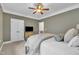 Bedroom showcasing olive green walls, a metal bed frame, a ceiling fan, double closets, and plush carpet at 3007 Krogen Ct, Creedmoor, NC 27522