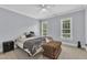 Charming bedroom with a queen bed, padded bench, and two bright windows at 3007 Krogen Ct, Creedmoor, NC 27522