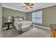 Bedroom with olive green walls, a metal bed frame, a ceiling fan, and large windows at 3007 Krogen Ct, Creedmoor, NC 27522