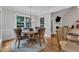 Breakfast nook with a round glass top table, 4 chairs, hardwood floors, and a view into the living room at 3007 Krogen Ct, Creedmoor, NC 27522