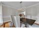 Elegant dining room features modern chandelier and wainscoting wall trim detail at 3007 Krogen Ct, Creedmoor, NC 27522