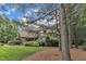 Beautiful home with stone and shingle exterior, manicured landscaping, and mature trees at 3007 Krogen Ct, Creedmoor, NC 27522