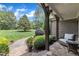 Charming front porch with stone flooring, comfortable seating, and a view of the lush front yard at 3007 Krogen Ct, Creedmoor, NC 27522