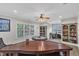 Spacious game room with custom built-ins, ceiling fan, and large windows providing natural light at 3007 Krogen Ct, Creedmoor, NC 27522