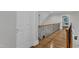 Second story hallway with wooden floors and wood and iron railing at 3007 Krogen Ct, Creedmoor, NC 27522