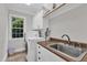 Bright laundry room with a stainless steel sink, white cabinets, and a washing machine at 3007 Krogen Ct, Creedmoor, NC 27522