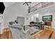 Open-concept living room with high ceilings, hardwood floors, and elegant furnishings at 3007 Krogen Ct, Creedmoor, NC 27522