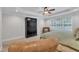 Main bedroom with a ceiling fan, tray ceiling, and large black cabinet at 3007 Krogen Ct, Creedmoor, NC 27522