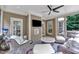 Inviting sun room features comfortable seating, tile-topped table, and a ceiling fan at 3007 Krogen Ct, Creedmoor, NC 27522