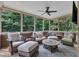 Sun room with comfortable seating, tile-topped table, ceiling fan and tree view at 3007 Krogen Ct, Creedmoor, NC 27522