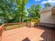 Spacious wooden deck overlooking a large backyard with mature trees at 3025 Creek Moss Ave, Wake Forest, NC 27587