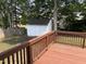Wooden deck overlooking backyard and shed with mature trees providing lots of shade at 3025 Creek Moss Ave, Wake Forest, NC 27587