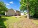 Exterior of home featuring a wooden deck and large backyard with mature trees at 3025 Creek Moss Ave, Wake Forest, NC 27587