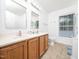 Bathroom with a double vanity, wood cabinets, tile floor, and large mirror at 3025 Creek Moss Ave, Wake Forest, NC 27587