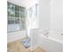 Bright bathroom with a large window, tile flooring, and a relaxing soaking tub at 3025 Creek Moss Ave, Wake Forest, NC 27587