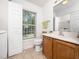 Bathroom with wood cabinets, tile floor, toilet and window at 3025 Creek Moss Ave, Wake Forest, NC 27587