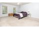 Bedroom with carpet, ceiling fan, two windows, and stylish décor at 3025 Creek Moss Ave, Wake Forest, NC 27587