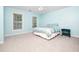 Cozy bedroom featuring two windows, neutral carpet, and light blue walls at 3025 Creek Moss Ave, Wake Forest, NC 27587