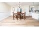 Bright dining room features a chandelier, wood table, and doors to the backyard at 3025 Creek Moss Ave, Wake Forest, NC 27587