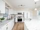 Bright kitchen with granite countertops, white cabinets and stainless steel appliances at 3025 Creek Moss Ave, Wake Forest, NC 27587