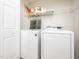Laundry room with washer, dryer, overhead shelving, and white door at 3025 Creek Moss Ave, Wake Forest, NC 27587