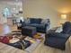 Comfortable living room showcasing a sofa, armchair, and decorative rug at 3025 Creek Moss Ave, Wake Forest, NC 27587