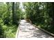Picturesque nature trail featuring an elevated wooden walkway through a lush green forest at 3025 Creek Moss Ave, Wake Forest, NC 27587
