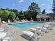 Community pool with plenty of seating, umbrellas and chairs for residents' relaxation at 3025 Creek Moss Ave, Wake Forest, NC 27587