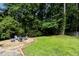 Outdoor living area with chairs arranged around a gravel area in backyard at 305 Burkwood Ln, Raleigh, NC 27609