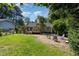 This backyard features an outdoor living area with seating and a wooden deck at 305 Burkwood Ln, Raleigh, NC 27609