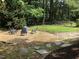 This yard has a gravel seating area with four chairs and natural stone pavers at 305 Burkwood Ln, Raleigh, NC 27609