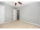 Bedroom with neutral walls and carpet and door to hall at 305 Burkwood Ln, Raleigh, NC 27609