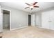 Bedroom with neutral walls and carpet, fan, and ensuite bath access at 305 Burkwood Ln, Raleigh, NC 27609