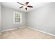 This bedroom features neutral carpet and a window with lots of natural light at 305 Burkwood Ln, Raleigh, NC 27609