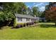Well-maintained home featuring manicured front yard and lush, mature landscaping at 305 Burkwood Ln, Raleigh, NC 27609