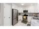 Bright kitchen featuring stainless steel appliances, granite counters and white cabinets at 305 Burkwood Ln, Raleigh, NC 27609