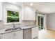 Bright kitchen featuring stainless steel appliances, granite counters and a view to the back yard at 305 Burkwood Ln, Raleigh, NC 27609