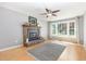 Cozy living room featuring a brick fireplace, hardwood floors, and large windows at 305 Burkwood Ln, Raleigh, NC 27609
