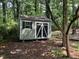 This well-maintained yard has a shed with double doors and decorative shutters at 305 Burkwood Ln, Raleigh, NC 27609