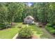 Aerial view of a charming home surrounded by lush greenery, showcasing a well-maintained yard at 310 Cross Lake, Fuquay Varina, NC 27526