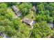 Expansive aerial view showcases multiple homes surrounded by lush greenery and mature trees at 310 Cross Lake, Fuquay Varina, NC 27526